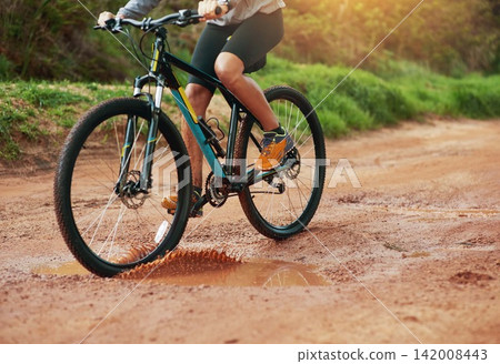 Legs, woman and mountain bike outdoors, fitness and cycling sports for adventure on trail. Female person, athlete and bicycle for exercise in nature, workout and training for off road competition Legs, woman and mountain bike outdoors, fitness and cycling sports for adventure on trail. Female person, athlete and bicycle for exercise in nature, workout and training for off road competition 142008443