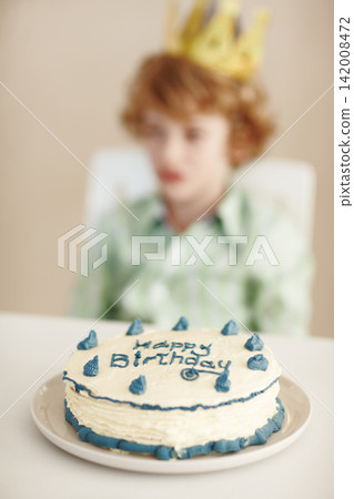 Birthday party, cake and blur on boy by table in family home for celebration, growth and development. Dessert, decoration and sweet pastry for event, gift and food for child in dining room at house Birthday party, cake and blur on boy by table in family home for celebration, growth and development. Dessert, decoration and sweet pastry for event, gift and food for child in dining room at house 142008472