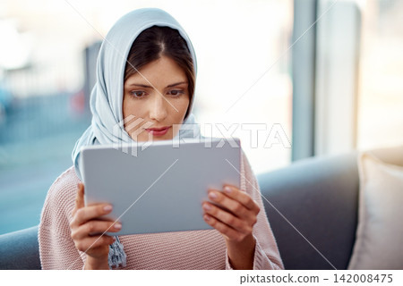 Relax, tablet and muslim woman on sofa in living room streaming movie, film or show for entertainment at home. Rest, digital technology and islamic female person watching video online at apartment. Relax, tablet and muslim woman on sofa in living room streaming movie, film or show for entertainment at home. Rest, digital technology and islamic female person watching video online at apartment. 142008475
