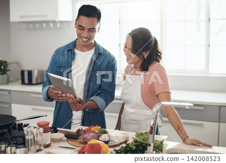 Tablet, cooking and couple in kitchen together with healthy food, relationship or happy in home. Diet, digital app or online recipe search with man, woman and help with nutrition, lunch and meal prep 142008523
