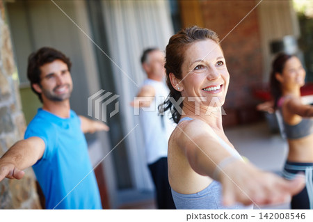 Woman, pose and happy in yoga class for fitness and mental wellbeing, workout and daily lesson to coach people. Female yogini, warrior posture and yogis or students practice strength and balance. Woman, pose and happy in yoga class for fitness and mental wellbeing, workout and daily lesson to coach people. Female yogini, warrior posture and yogis or students practice strength and balance. 142008546