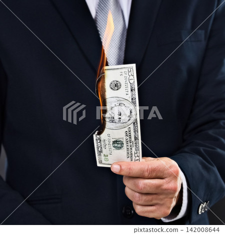 Person, hand and burn money notes as entrepreneur for wealth, rich and corruption of economy. American dollar, paper or cash with business inflation, finances and bankruptcy with currency rate Person, hand and burn money notes as entrepreneur for wealth, rich and corruption of economy. American dollar, paper or cash with business inflation, finances and bankruptcy with currency rate 142008644