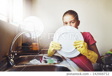 Portrait, washing dishes or kid with plate and gloves in kitchen sink in home for healthy hygiene. Learning, development or girl cleaning with water or soap to disinfect of mess, bacteria or germs Portrait, washing dishes or kid with plate and gloves in kitchen sink in home for healthy hygiene. Learning, development or girl cleaning with water or soap to disinfect of mess, bacteria or germs 142008712