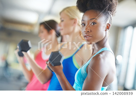 Black woman, portrait gym and workout with dumbbell for muscle, strong body and training class. African athlete, exercise and weightlifting in wellness club with fitness, healthy friends and energy Black woman, portrait gym and workout with dumbbell for muscle, strong body and training class. African athlete, exercise and weightlifting in wellness club with fitness, healthy friends and energy 142008939