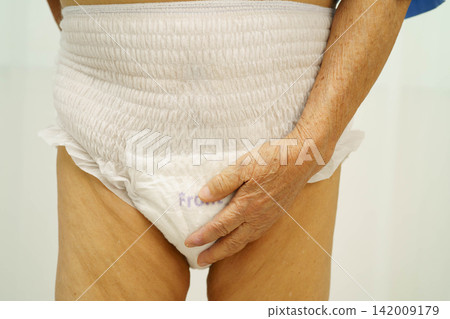 Asian senior woman patient wearing adult incontinence diaper pad in hospital. Asian senior woman patient wearing adult incontinence diaper pad in hospital. 142009179