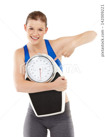 Portrait of woman, pointing and scale in studio for measurement, smile and excited for results of diet. Female person, body and care for calories target or goals, weight loss and white background 142009221