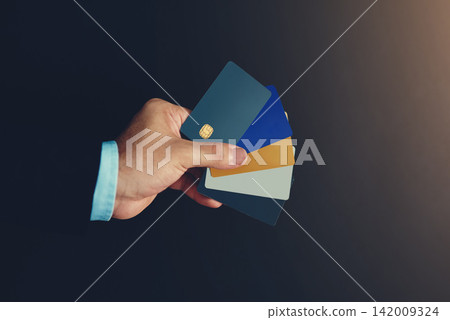 Businessman, hand and credit card in studio for wireless transaction, credit score and accounting. Financial advisor, payment and e commerce on dark background for payment authorisation and sales Businessman, hand and credit card in studio for wireless transaction, credit score and accounting. Financial advisor, payment and e commerce on dark background for payment authorisation and sales 142009324