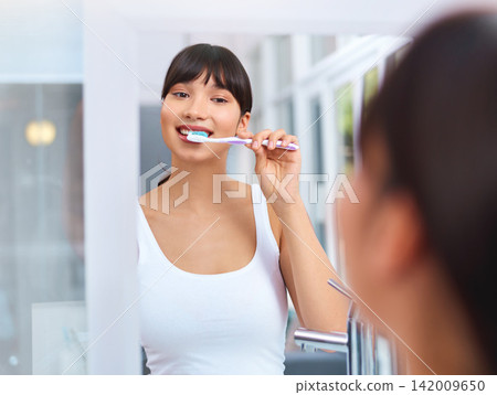 Woman, brush and teeth in bathroom with mirror for dental in portrait with confidence for health. House, smile and self care with pride for clean mouth in morning with hygiene for routine with fresh Woman, brush and teeth in bathroom with mirror for dental in portrait with confidence for health. House, smile and self care with pride for clean mouth in morning with hygiene for routine with fresh 142009650