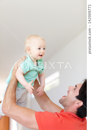 Father, toddler and play game for fun, love and bonding for child development in home. Happy daddy, boy and holding in embrace or single parent in living room, comfort and security in connection 142009771
