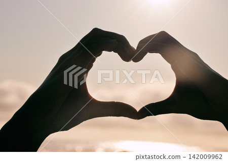 Silhouette, heart hands and couple at beach for sunset, love and bonding for care together on summer holiday. Shadow, closeup and romance at ocean sea for peace, support and emoji sign for connection Silhouette, heart hands and couple at beach for sunset, love and bonding for care together on summer holiday. Shadow, closeup and romance at ocean sea for peace, support and emoji sign for connection 142009962