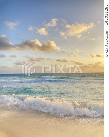 Resort beach morning waves spray vertical Resort beach morning waves spray vertical 142011269