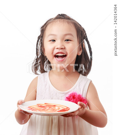 A smiling girl holds an empty plate she has just finished eating, laughing heartily against a white background, showcasing the joy of culinary art. A smiling girl holds an empty plate she has just finished eating, laughing heartily against a white background, showcasing the joy of culinary art. 142014364