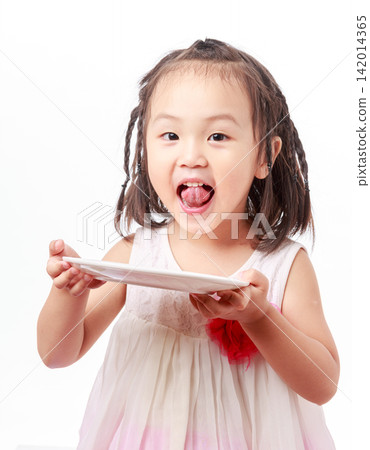 A smiling girl holds an empty plate she has just finished eating, laughing heartily against a white background, showcasing the joy of culinary art. A smiling girl holds an empty plate she has just finished eating, laughing heartily against a white background, showcasing the joy of culinary art. 142014365