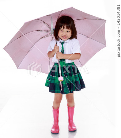 Cute little Asian schoolgirl in uniform holding pink umbrella isolated on white background Cute little Asian schoolgirl in uniform holding pink umbrella isolated on white background 142014381