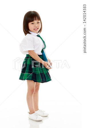 Portrait of happy Asian primary school student holding books isolated on white Portrait of happy Asian primary school student holding books isolated on white 142014383