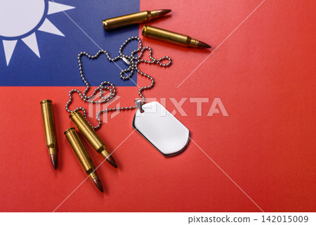 A dog tag on the taiwanese flag, serving as a conceptual backdrop representing defense A dog tag on the taiwanese flag, serving as a conceptual backdrop representing defense 142015009