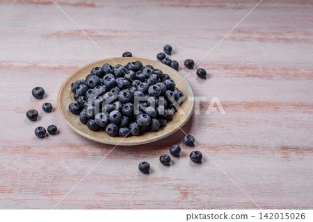Fresh, ripe, and juicy wild blueberries as an ingredient for vegetarian dishes Fresh, ripe, and juicy wild blueberries as an ingredient for vegetarian dishes 142015026