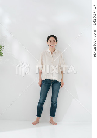 A smiling woman in a white shirt A smiling woman in a white shirt 142017417