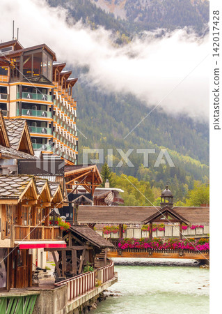 Chamonix Mont Blanc French Alps France Arve river, bridge with red flowers and chalet 142017428
