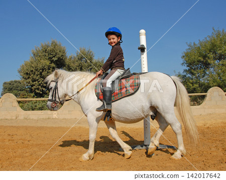 riding child and pony riding child and pony 142017642