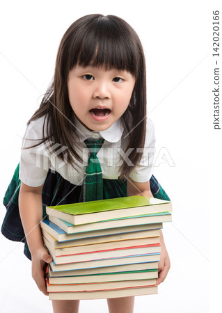 Tired little student carrying a heavy stack of textbooks looking exhausted in studio. Tired little student carrying a heavy stack of textbooks looking exhausted in studio. 142020166