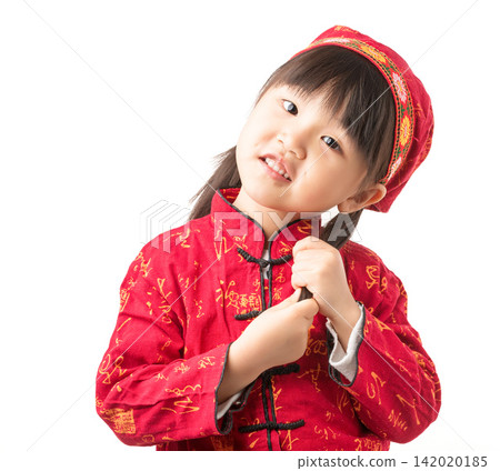 Adorable little girl in traditional red Chinese clothes tilting head and touching her pigtail. Adorable little girl in traditional red Chinese clothes tilting head and touching her pigtail. 142020185