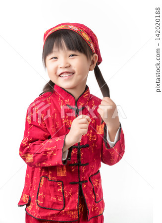 Adorable little girl in traditional red Chinese clothes tilting head and touching her pigtail. Adorable little girl in traditional red Chinese clothes tilting head and touching her pigtail. 142020188