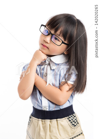 Pensive little girl looking away and thinking with her hand on chin against white background. 142020265