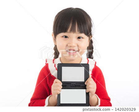 Smiling East Asian child holding a blank small blackboard frame for copy space. Smiling East Asian child holding a blank small blackboard frame for copy space. 142020329