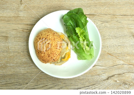 barbecue beef cheeseburger wholewheat bread stuffed mashed potato dressing gravy sauce and fresh vegetable salad on plate barbecue beef cheeseburger wholewheat bread stuffed mashed potato dressing gravy sauce and fresh vegetable salad on plate 142020899