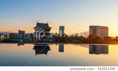 Kokura Castle with skyscraper reflection on pond at sunset, Kitakyushu Kokura Castle with skyscraper reflection on pond at sunset, Kitakyushu 142021206