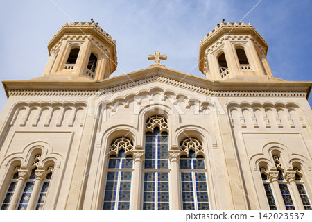 A grand, ornate Greek Orthodox church with two octagonal bell towers rising symmetrically from its main facade A grand, ornate Greek Orthodox church with two octagonal bell towers rising symmetrically from its main facade 142023537