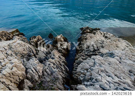 A dramatic interplay of textures and forms from a high vantage point over a rugged rocky coastline A dramatic interplay of textures and forms from a high vantage point over a rugged rocky coastline 142023616