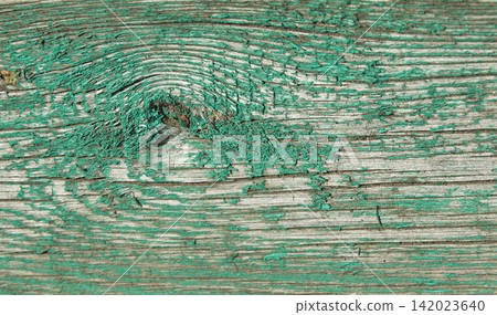 An old wooden board with peeling green paint. An old wooden board with peeling green paint. 142023640