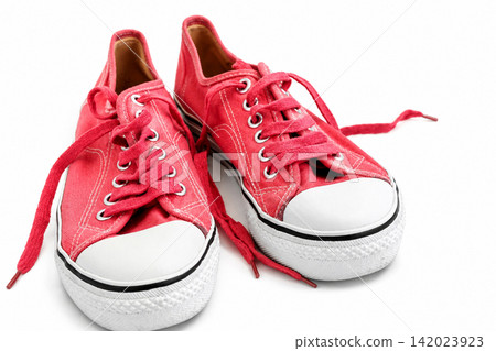 Crimson Canvas Sneakers with Untied Shoelaces on White Background Crimson Canvas Sneakers with Untied Shoelaces on White Background 142023923