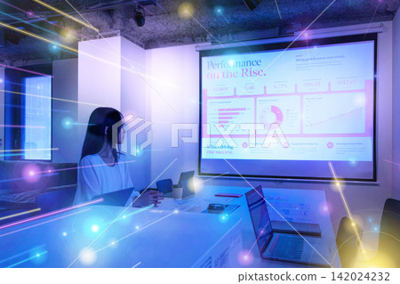 A woman looking at presentation materials in front of a projector. A woman looking at presentation materials in front of a projector. 142024232