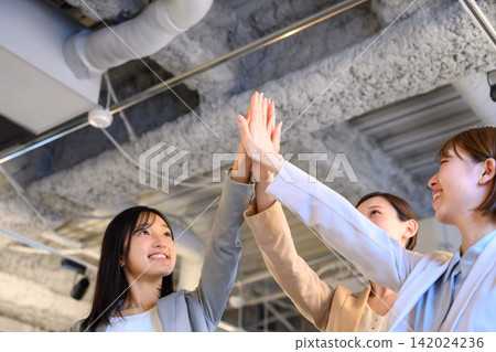 Business team celebrates with high-fives Business team celebrates with high-fives 142024236
