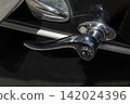 Tavernes Blanques, Spain - June 14, 2026. Close up view of a chrome door handle on a black vintage car with a classic design 142024396