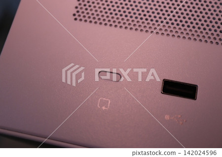 Close-Up of Electronic Device Ports and Speaker Grille Close-Up of Electronic Device Ports and Speaker Grille 142024596