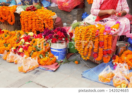 Marigold garlands and colorful flowers sold in the Kathmandu market 142024685