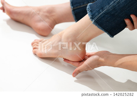 Woman touching the foot Woman touching the foot 142025282