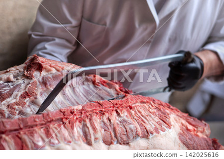 Preparing and cutting meat on the butcher's block Preparing and cutting meat on the butcher's block 142025616
