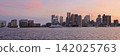 Boston skyline illuminated at dusk with Atlantic Ocean on the foreground, USA 142025763