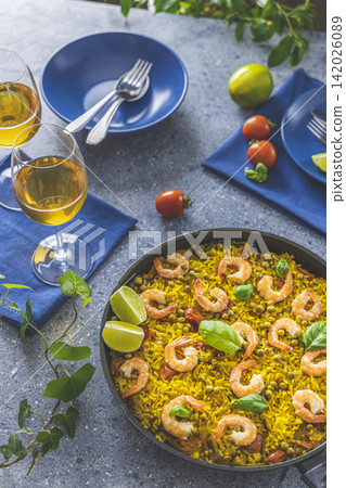 Traditional spanish seafood paella in the fry pan. Dinner served with wine. Traditional spanish seafood paella in the fry pan. Dinner served with wine. 142026089