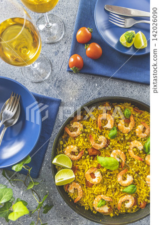 Traditional spanish seafood paella in the fry pan. Dinner served with wine. Traditional spanish seafood paella in the fry pan. Dinner served with wine. 142026090