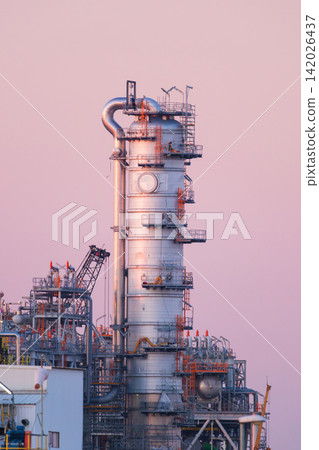 Industrial pipes and equipment at an oil refinery plant. Vertical photo. Industrial pipes and equipment at an oil refinery plant. Vertical photo. 142026437