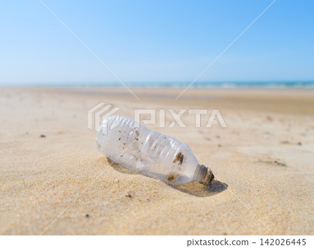 Plastic bottle on the beach. Plastic trash buried in the sand. Plastic bottle on the beach. Plastic trash buried in the sand. 142026445