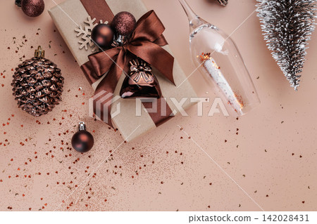 Top view of Christmas gift with pine cone and champagne glass Top view of Christmas gift with pine cone and champagne glass 142028431