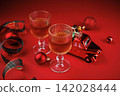 Holiday drinks with toy car and baubles on red background 142028444