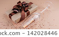 Elegant Christmas gift with brown ribbon and scattered glitter 142028446
